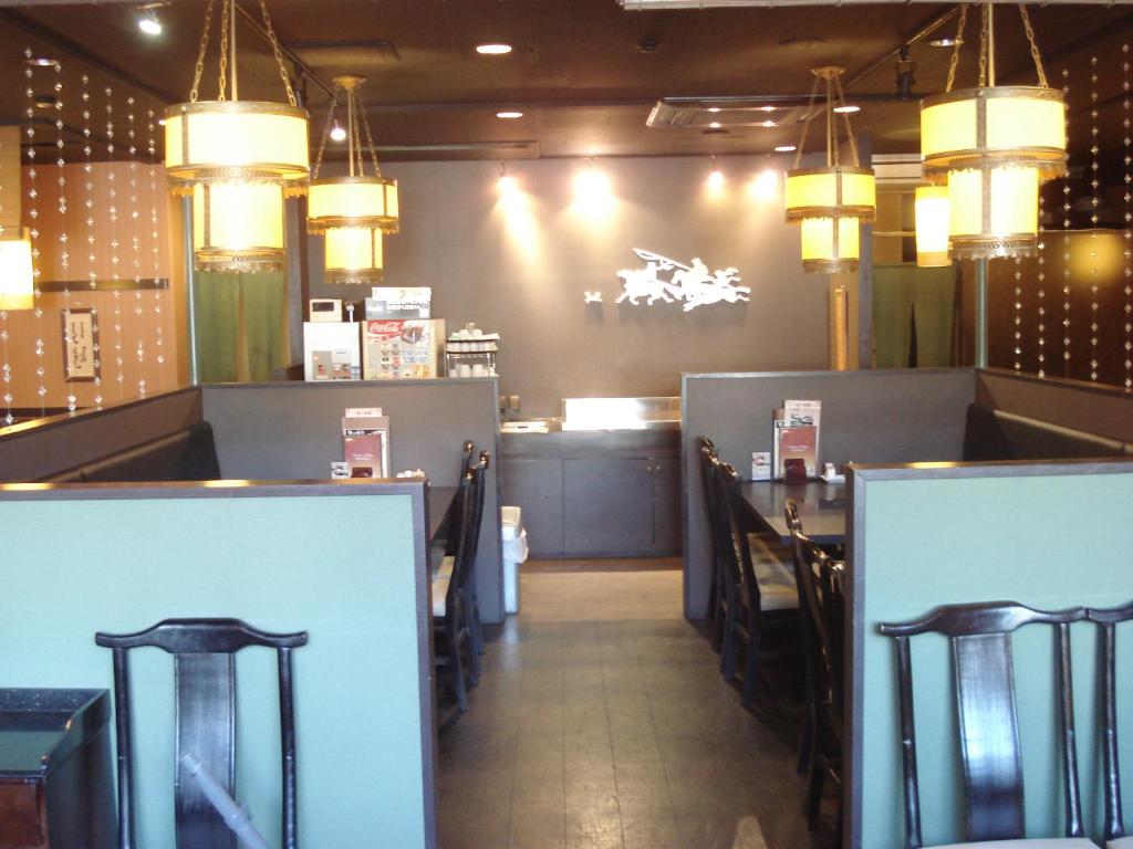 a dining room with chairs and a table and lights at Smile Hotel Sugamo in Tokyo