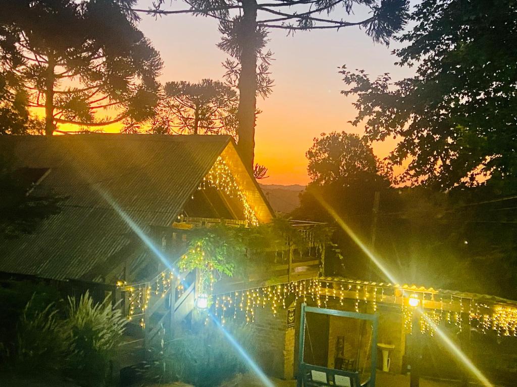 a house with christmas lights on it at sunset at Casa de Ines em Santana in São Marcos