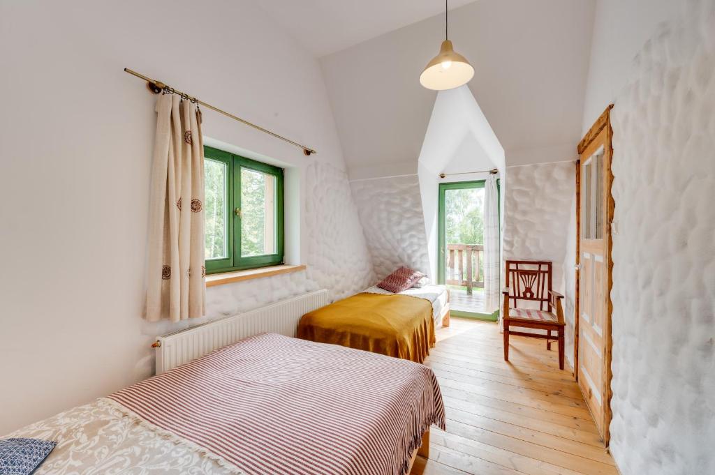 a bedroom with two beds and a window at Chyża Chata Górna 75m2 in Bystre