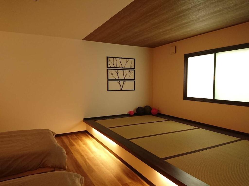 um quarto com tapetes com uma janela em Mari Beauty Salon 2F - Vacation STAY 16557v em Sado