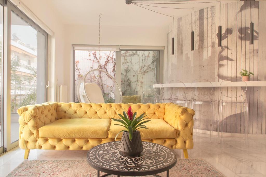a living room with a yellow couch and a table at Living Stone Bronze in Athens