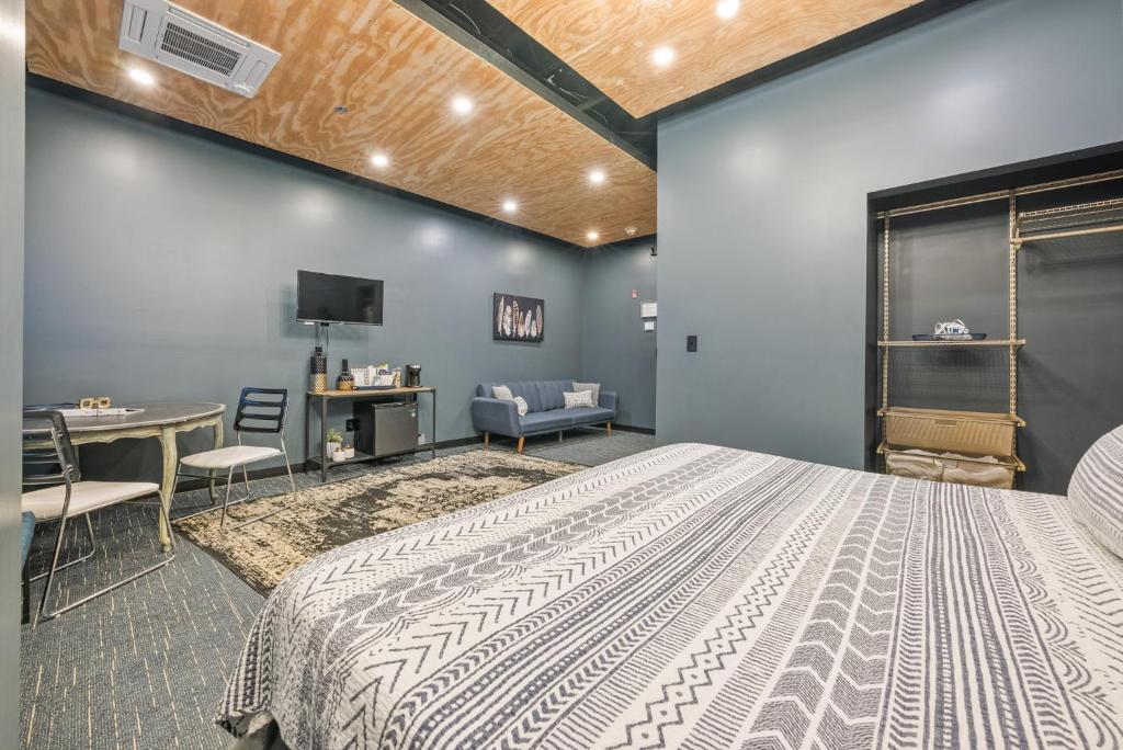 a bedroom with a bed and a desk and a tv at Indigo Pass Boutique Hotel in Middletown