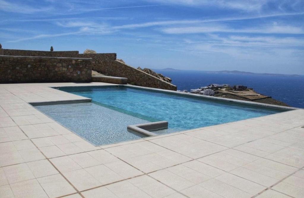a swimming pool with a view of the ocean at Villa Faros in Fanari