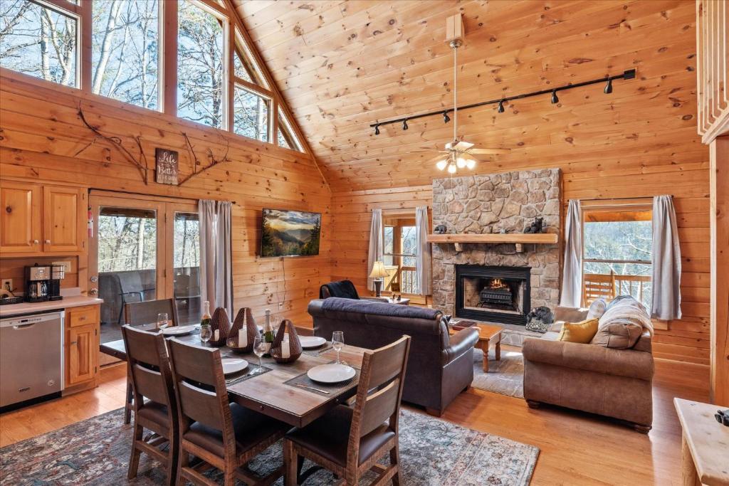 a living room with a table and a fireplace at SunnySierra Cabin in Sevierville