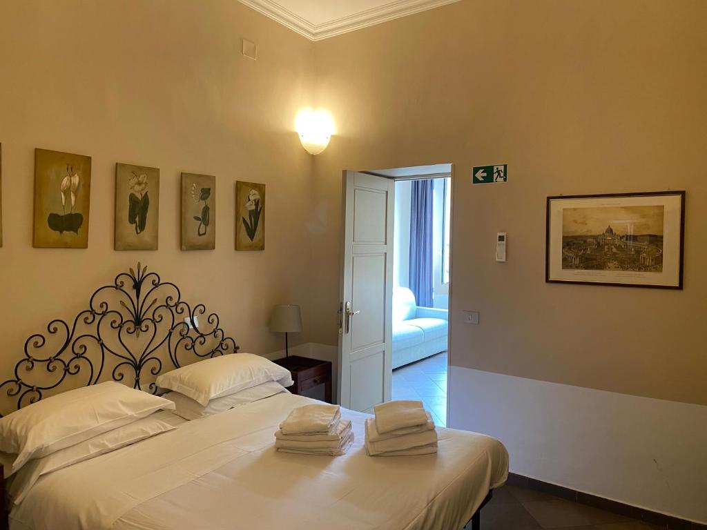 a bedroom with a bed with towels on it at 3House in Rome