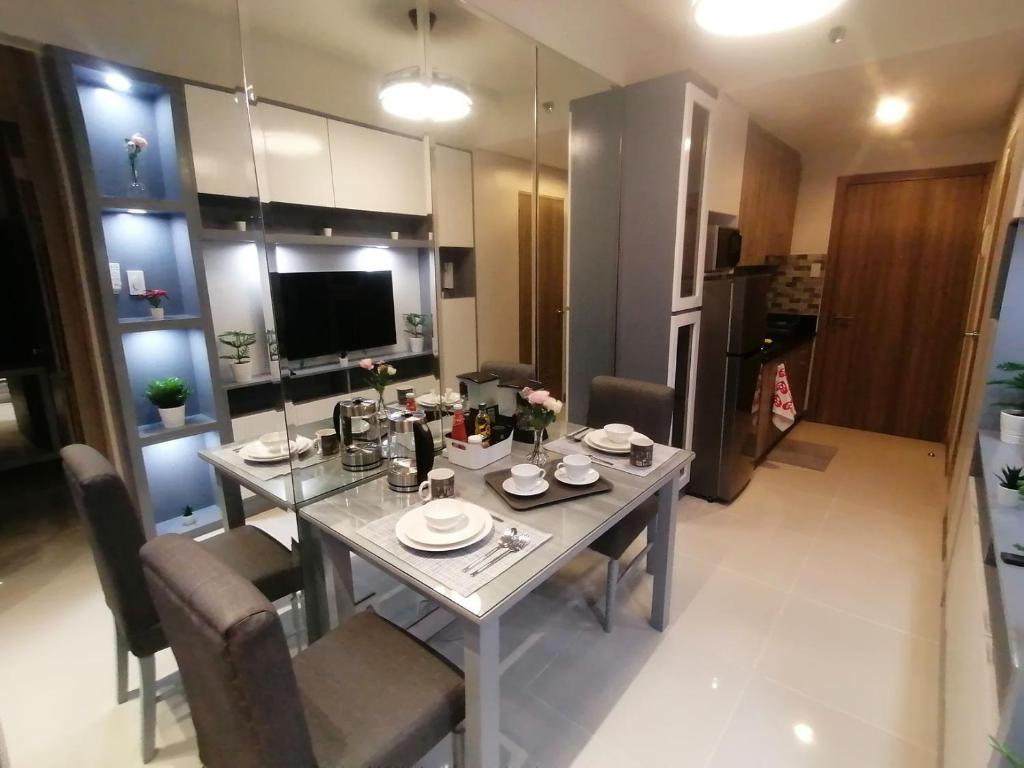 a dining room table and chairs in a kitchen at Cosy Luxy Coast Residences Staycation in Manila