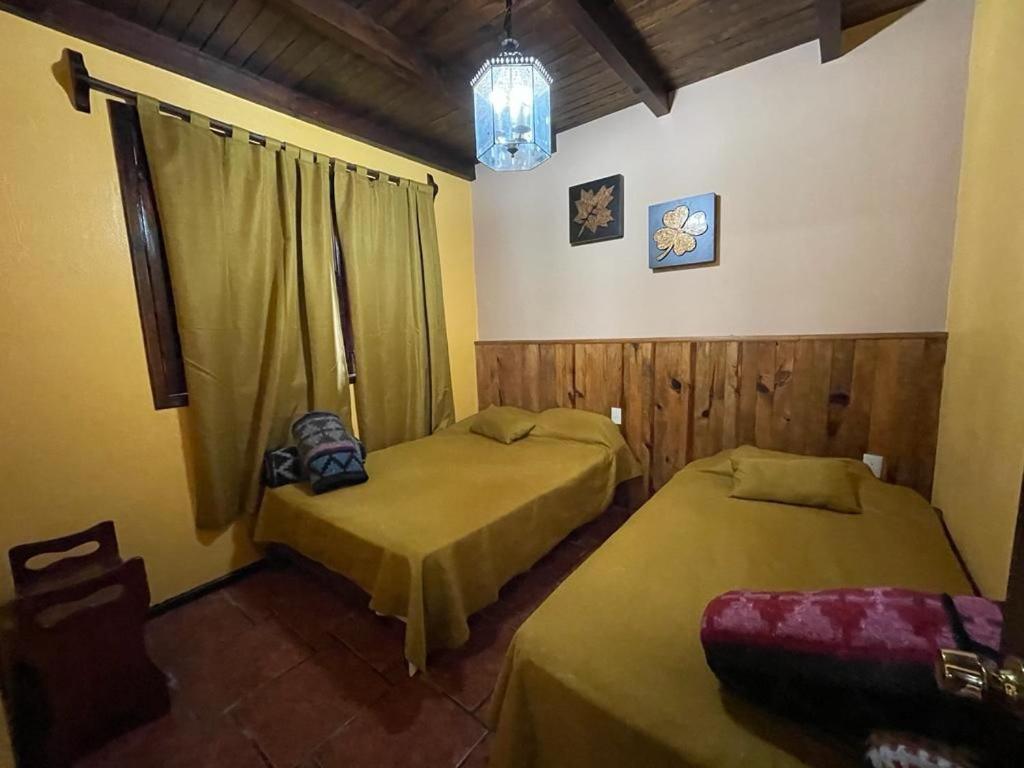Postel nebo postele na pokoji v ubytování Villas Lupita