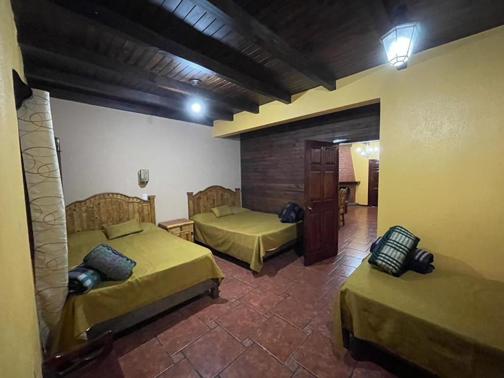 Postel nebo postele na pokoji v ubytování Villas Lupita