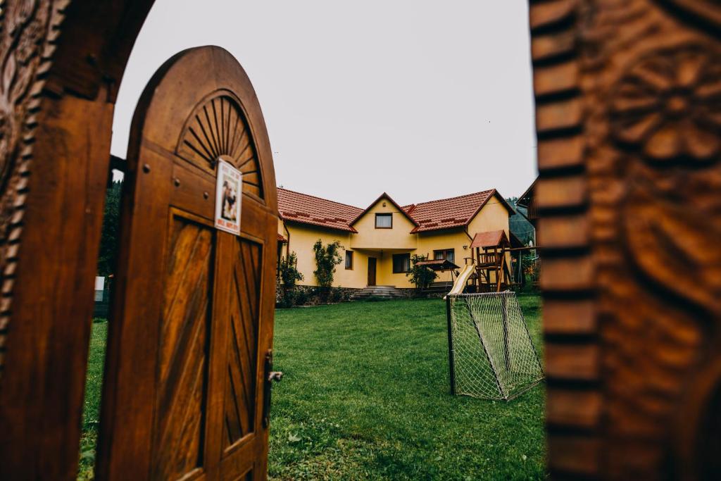 an open door in a yard with a house at Casa Roland in Gheorgheni