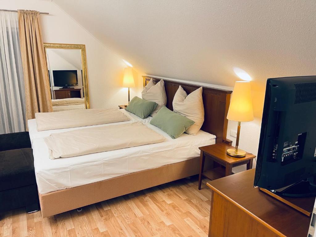 a bedroom with a bed and a television in it at Apartment am Hohlbach in Gruibingen in Gruibingen