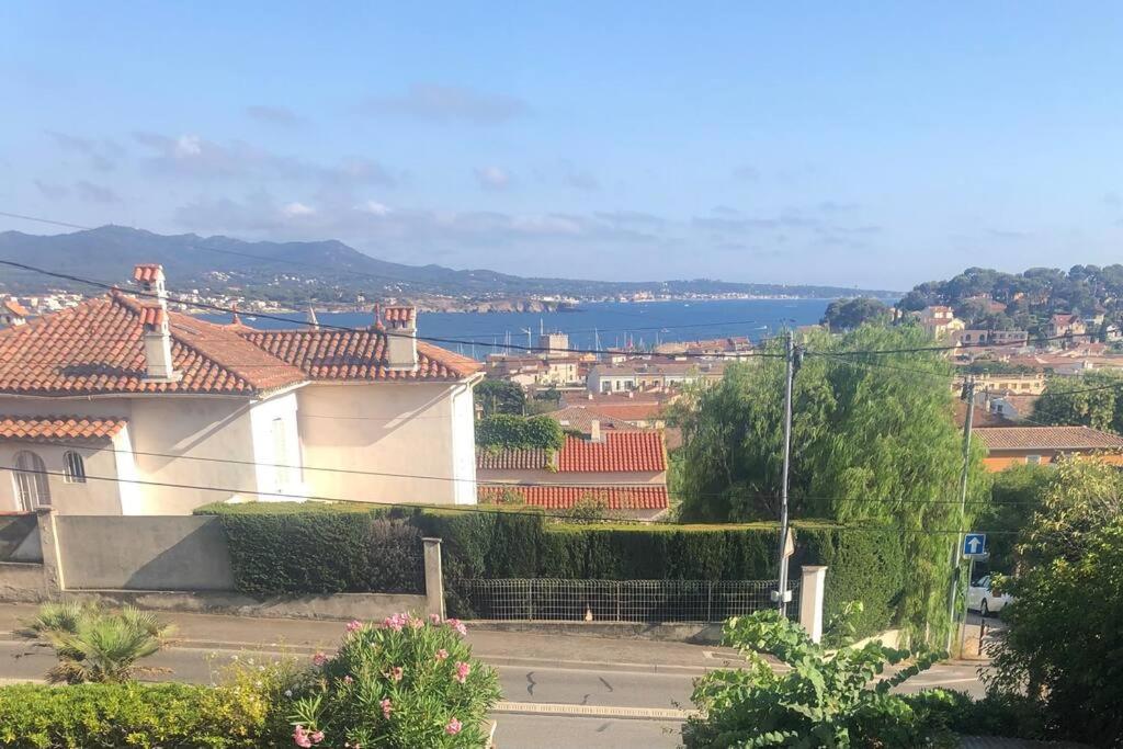 a view of a city with a house and the water at Belle vue sur mer, très près du port de Sanary in Sanary-sur-Mer