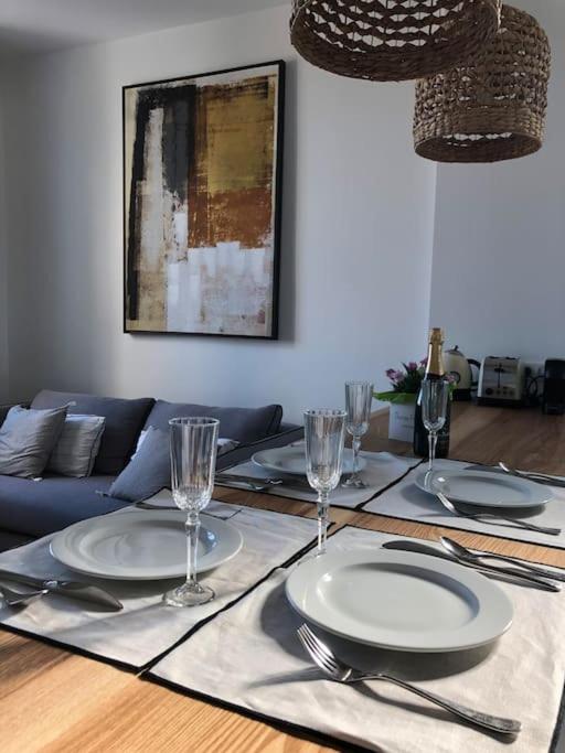 a dining room table with plates and glasses on it at Belle vue sur mer, très près du port de Sanary in Sanary-sur-Mer