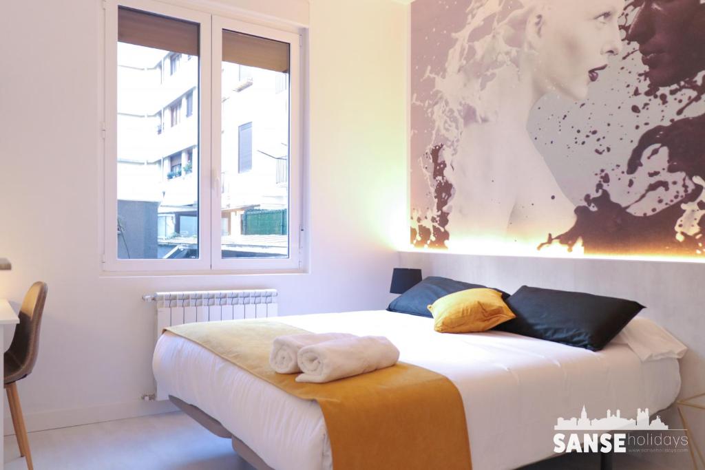 a bedroom with a bed and a large window at Apartamento Kursal by SanSe Holidays in San Sebastián