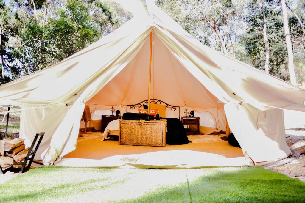 a large white tent with a table in it at Golden Point Glamping in Faraday