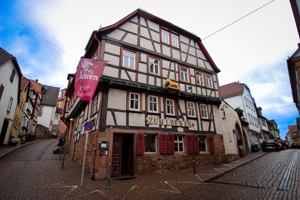 a black and white building on a city street at Hotel und Restaurant Zum Löwen in Gelnhausen