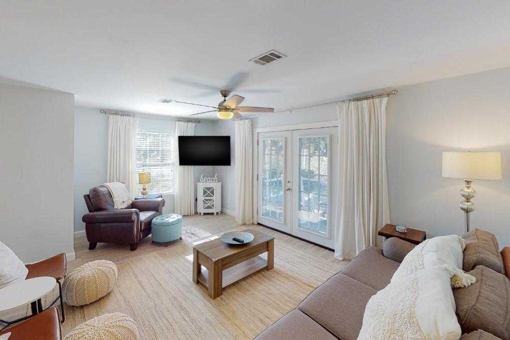 a living room with a couch and a tv at Summer Lake Townhomes 1 in Destin