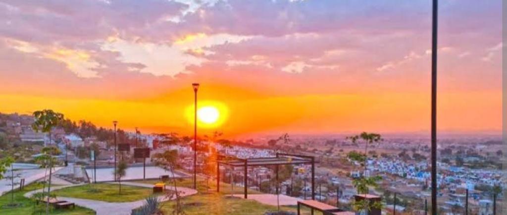 a view of a city with the sunset in the background at Torres casillas in Tonalá