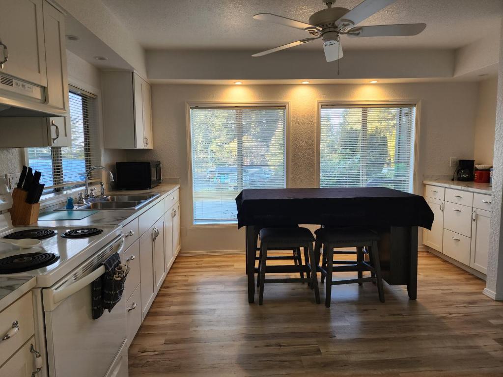 a kitchen with a black table in the middle of it at Plainview Motel in Coos Bay