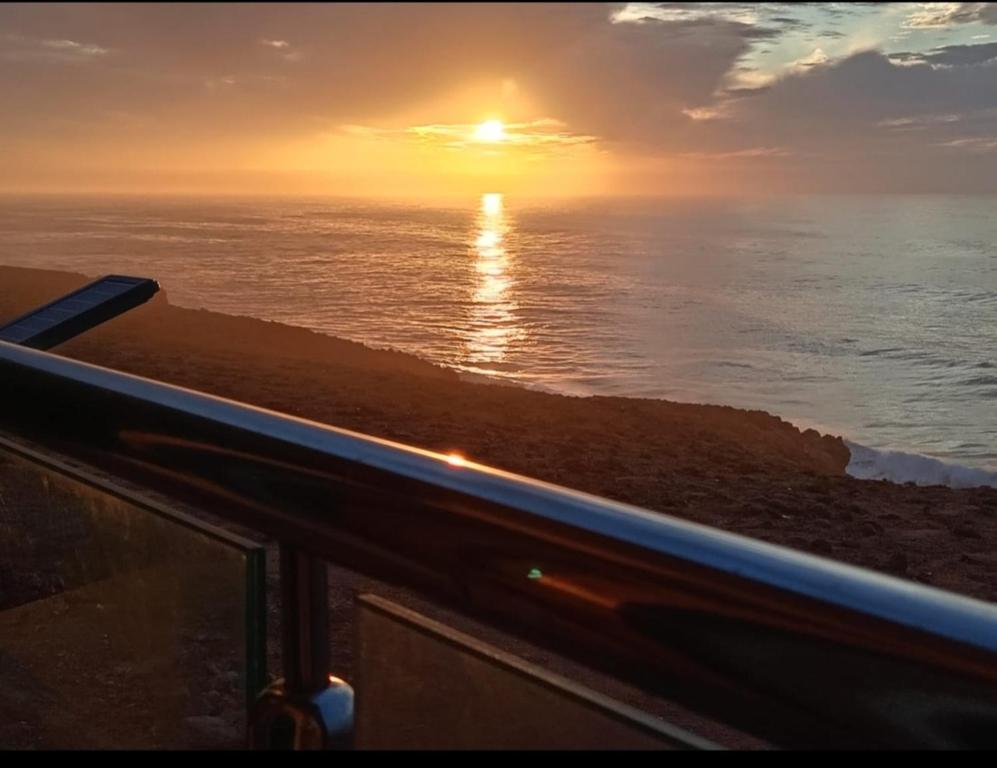 a sunset over the ocean from a cruise ship at Dar diafa samira in Mirleft