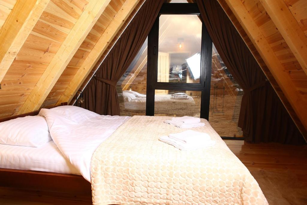 a bedroom with a bed in a attic at WOLFOREST in Žabljak