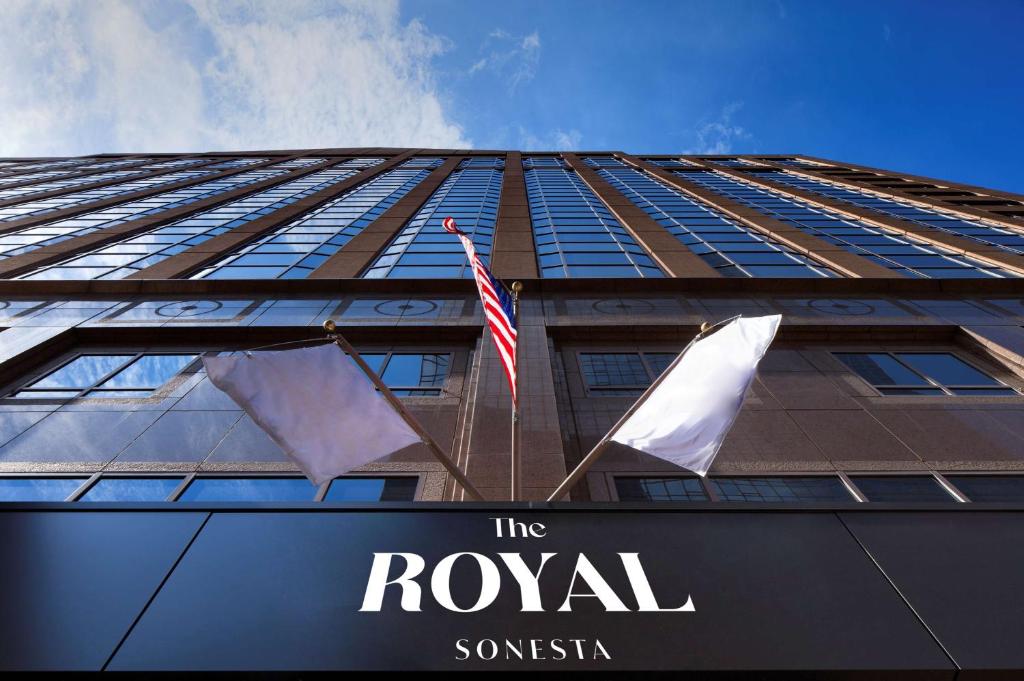 a tall building with two flags in front of it at The Royal Sonesta Minneapolis Downtown in Minneapolis