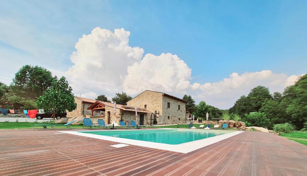 a swimming pool in front of a house at Quinta da Abadia in Mangualde