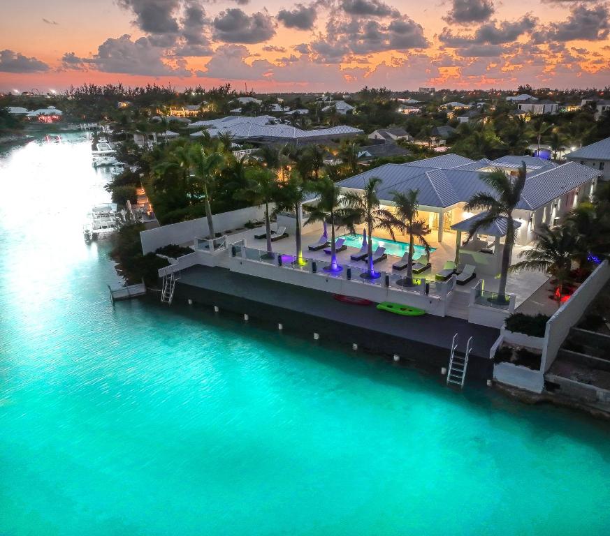 an aerial view of a resort next to the water at New Luxury 8 Bedroom Sunset Bay Villa in Long Bay Hills