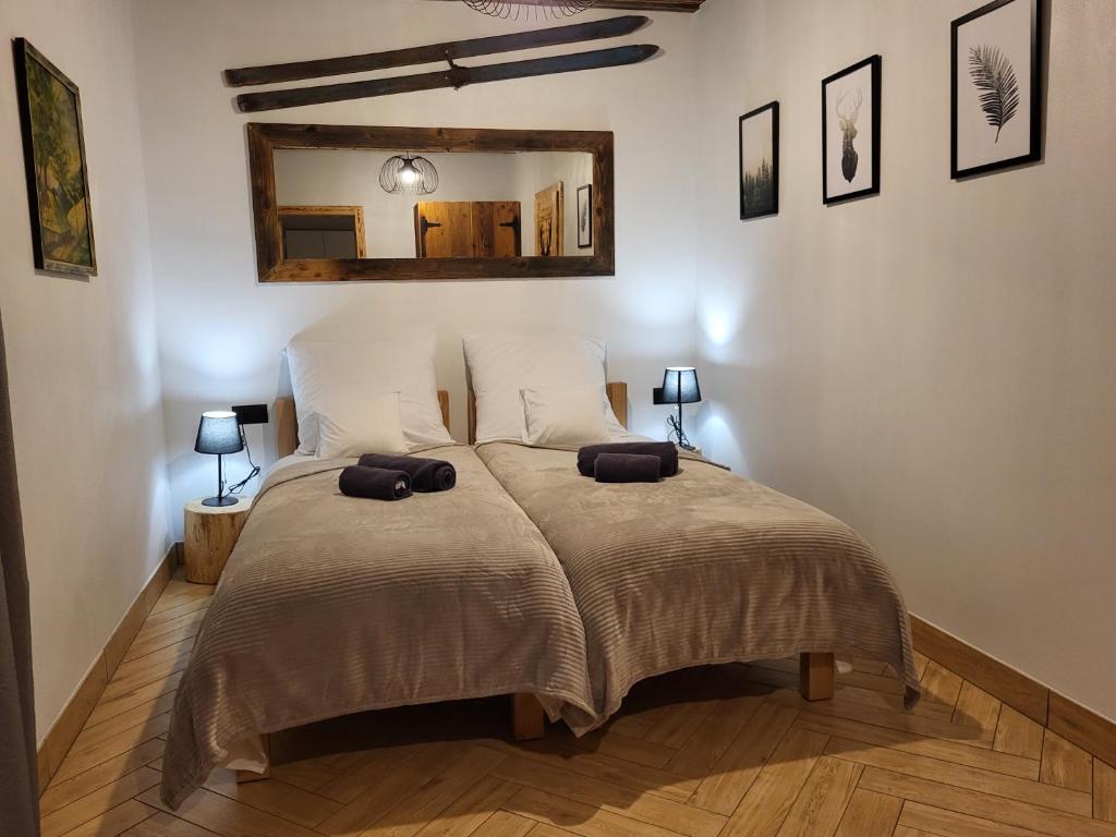 a bedroom with a bed with two pillows on it at Apartamenty Stylo in Istebna
