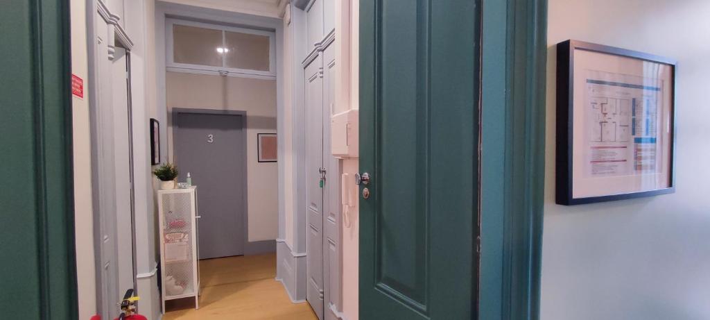 a hallway with a green door in a room at Vila Santa Cruz Guest House in Braga