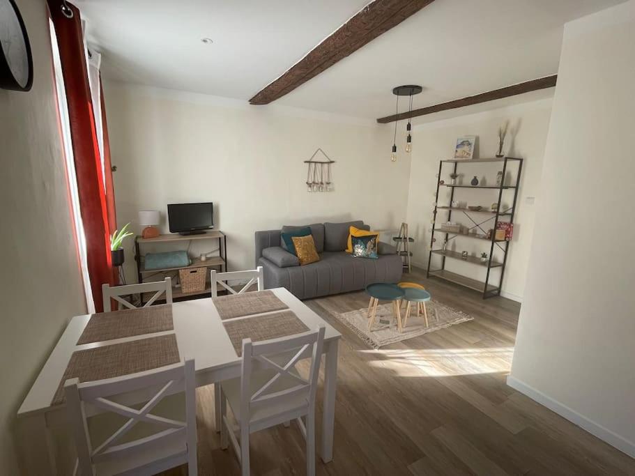 a living room with a table and a couch at L écrin Bandolais in Bandol