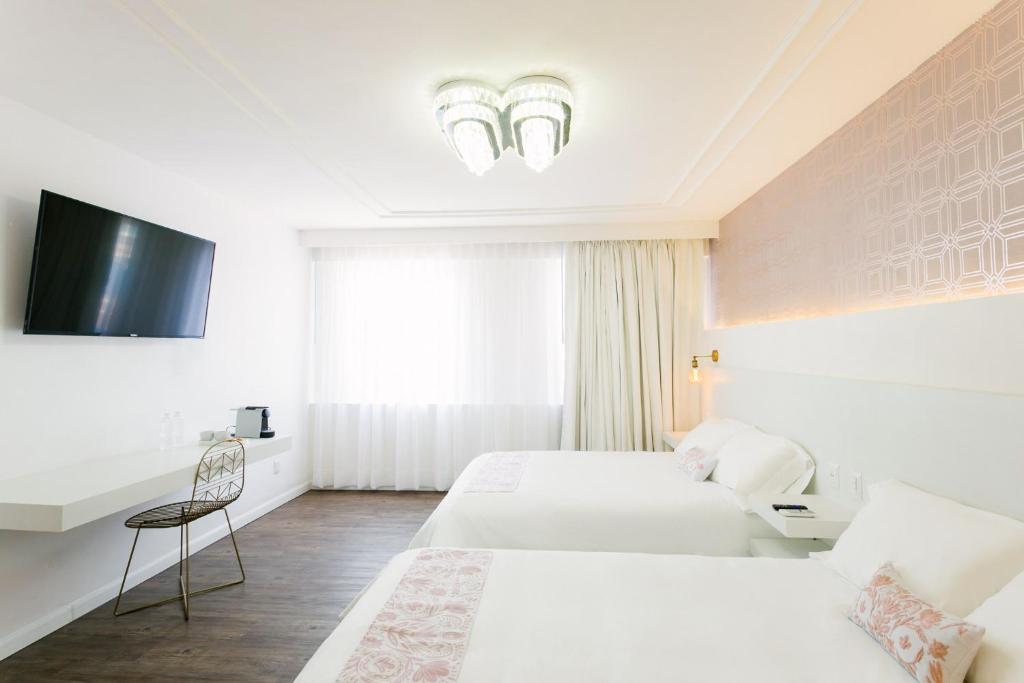 Postel nebo postele na pokoji v ubytování Casa Oxa Hotel