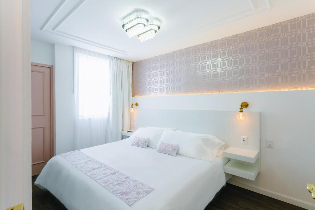 Postel nebo postele na pokoji v ubytování Casa Oxa Hotel