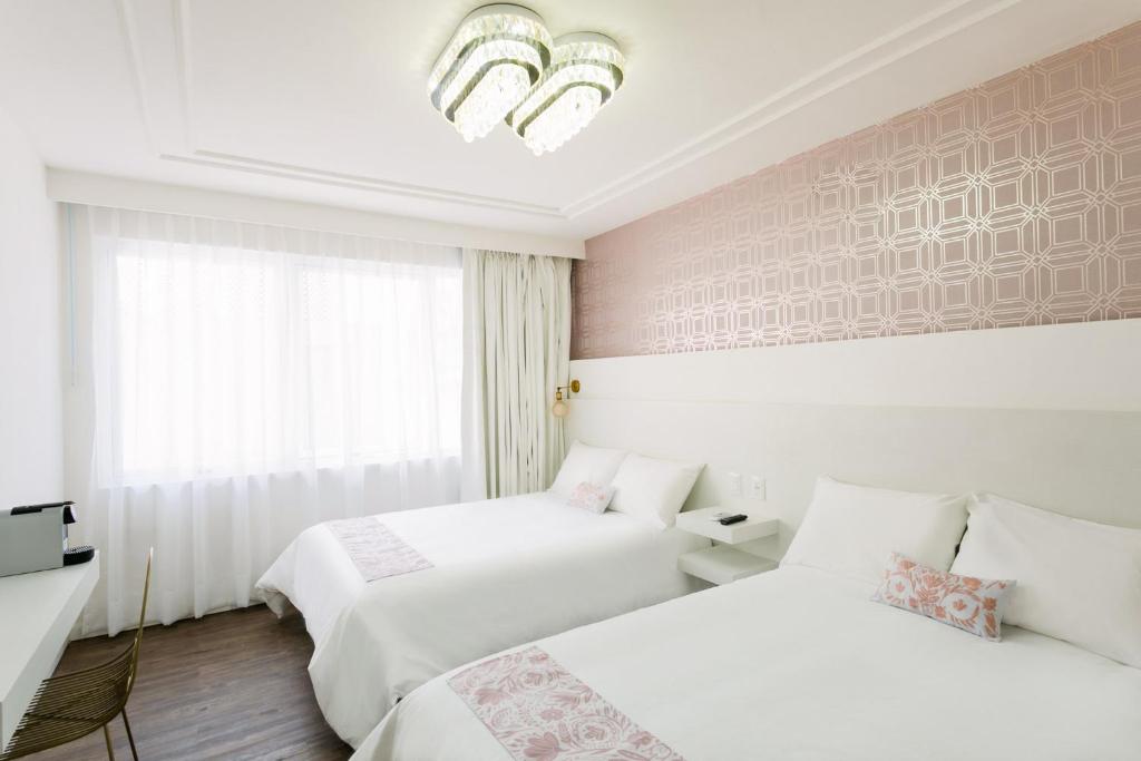 Postel nebo postele na pokoji v ubytování Casa Oxa Hotel