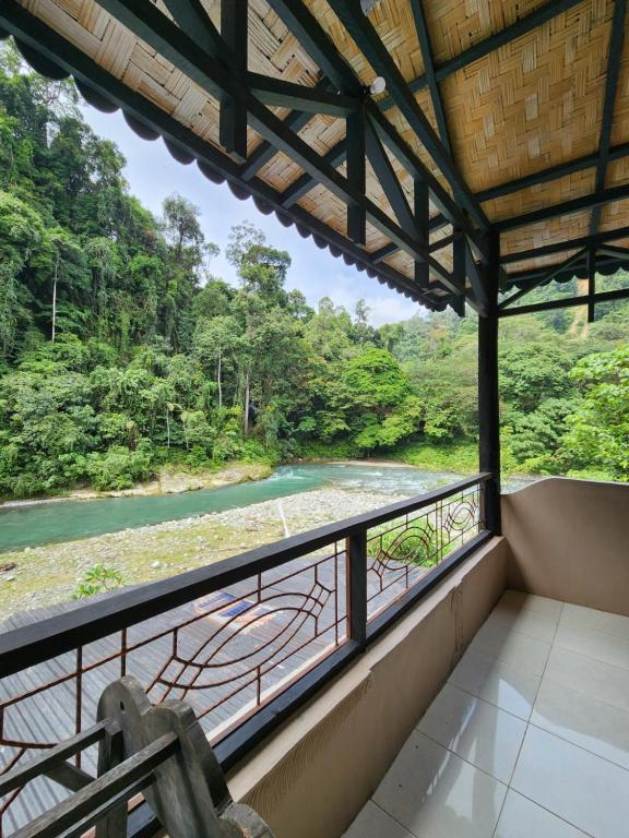 a balcony with a view of a river at Jungle Inn Bukit lawang in Bukit Lawang