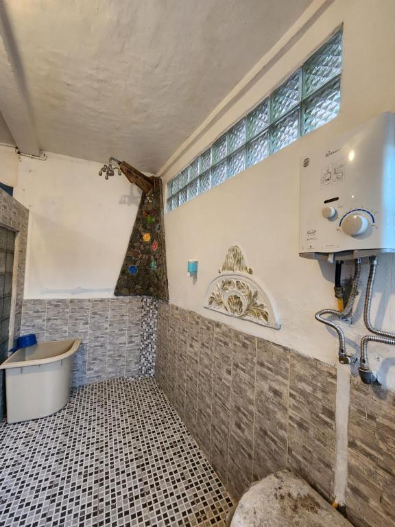 a bathroom with a tub and a sink at Jungle Inn Bukit lawang in Bukit Lawang