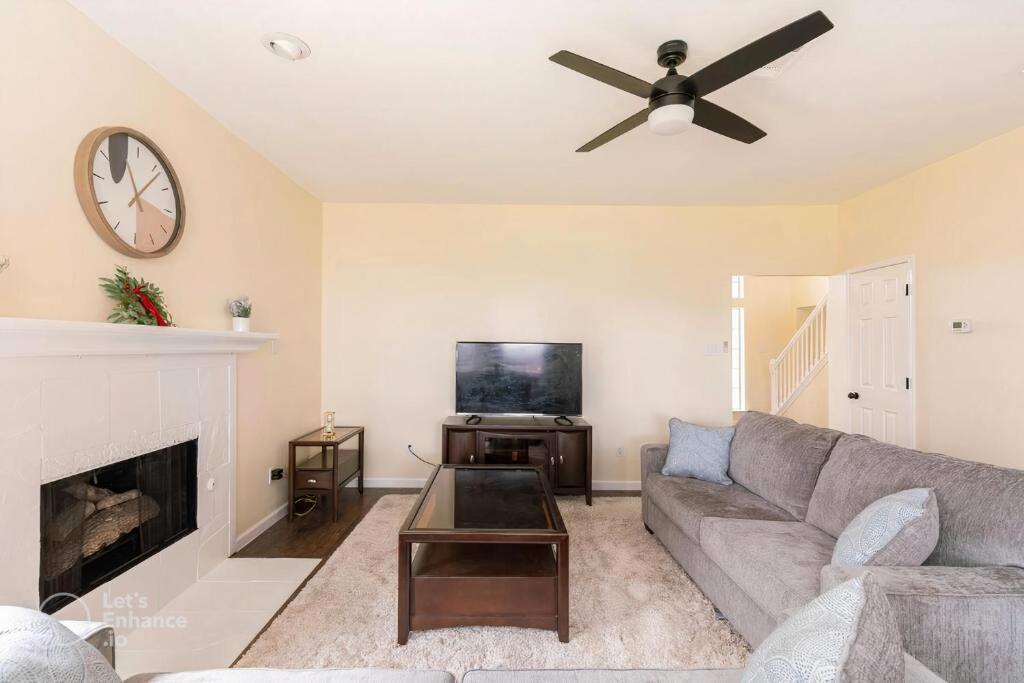 a living room with a couch and a fireplace at Grand Gem for Families - Games, Office, Backyard in Carrollton