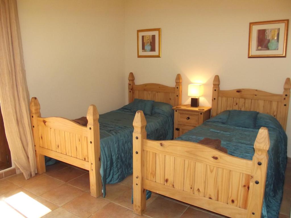 a bedroom with two twin beds and a lamp at Apartment on The Beach Front with Free Fibre Internet and Air Conditioning in Isla Canela