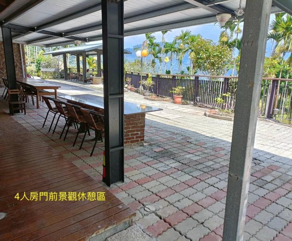 an outdoor patio with a table and chairs at Zhong Ming Ju Taoyi Fang in Fanlu