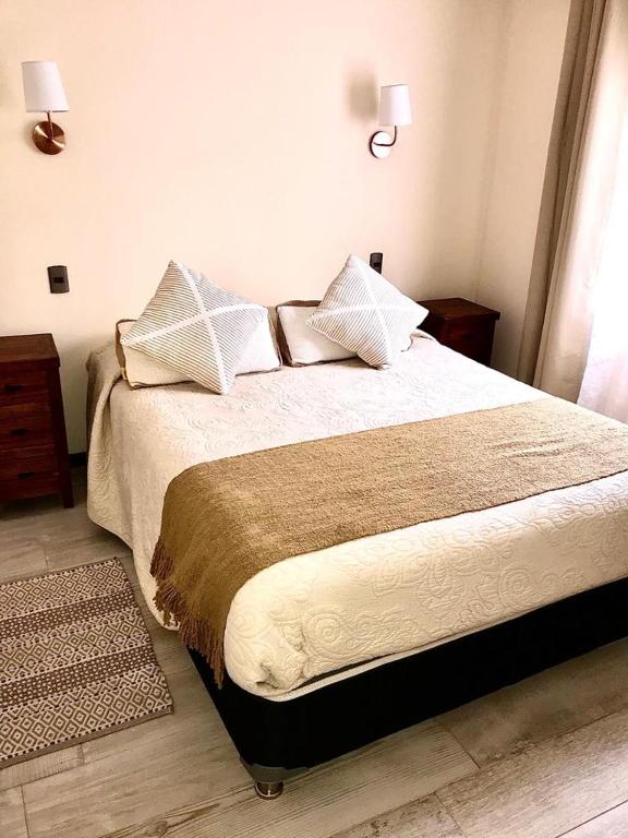 Postel nebo postele na pokoji v ubytování Departamentos y Cabañas Il Bosco