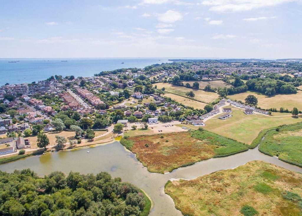 an aerial view of a town and a river at Salterns Village in Seaview