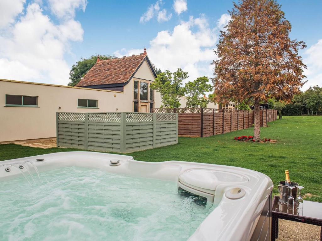 a hot tub in the backyard of a house at Chapel Barn in Bolnhurst