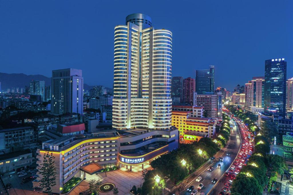 a city skyline at night with a tall building at Foreign Trade Centre C&D Hotel,Fuzhou in Fuzhou