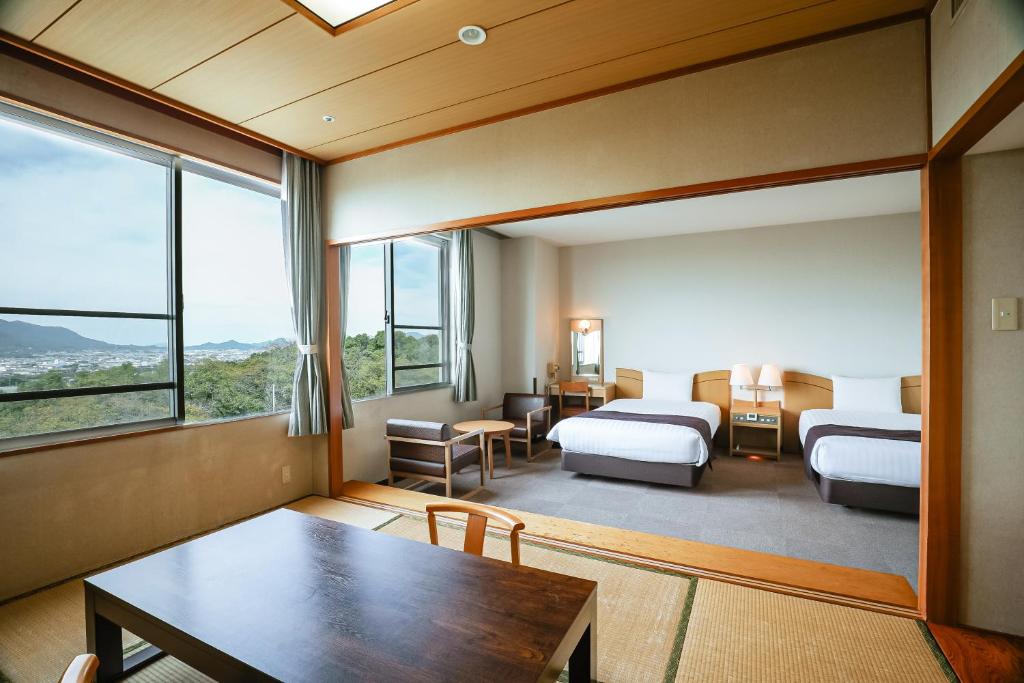 Postel nebo postele na pokoji v ubytování KAMENOI HOTEL Kanonji