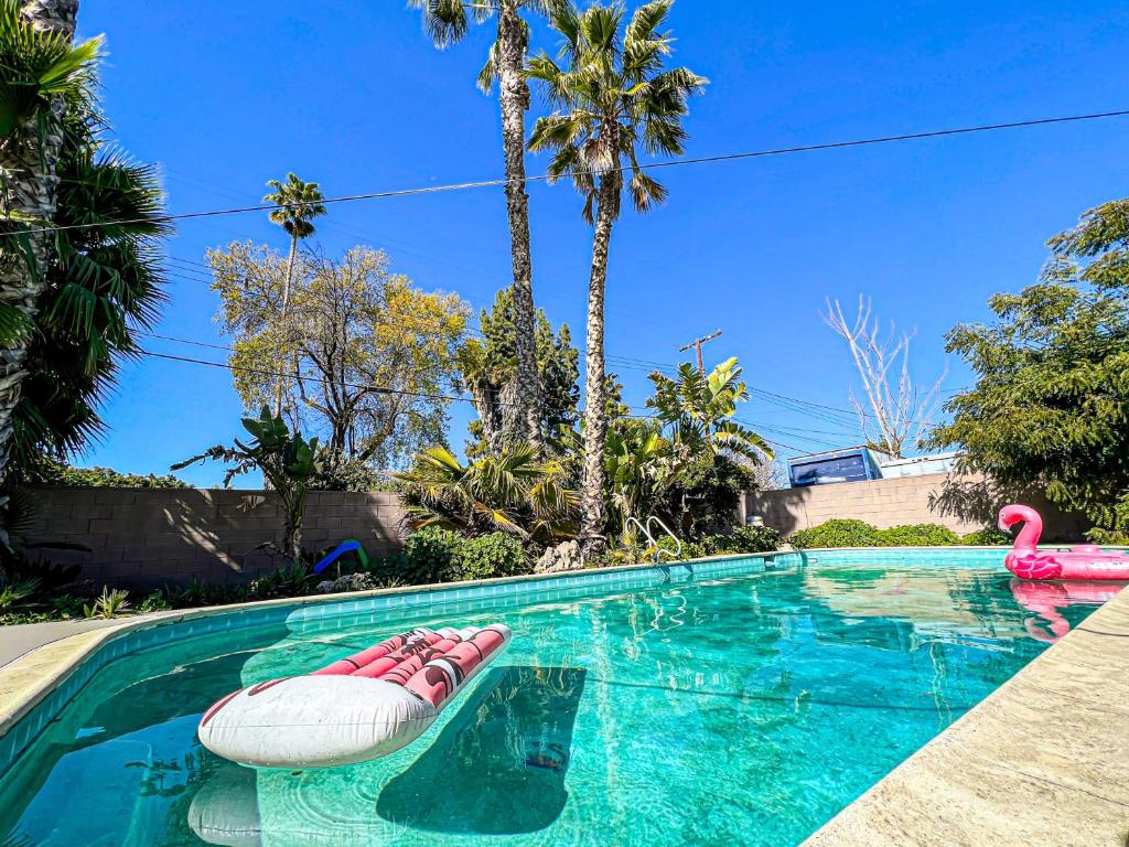 a swimming pool with a pink flamingo and a pool noodle in a house at Gorgeous 4BR House with Swimming Pool in Topanga