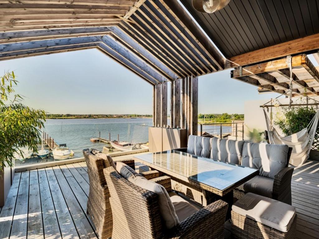 a patio with a table and chairs and a view of the water at Appartement Arcachon, 5 pièces, 8 personnes - FR-1-319-404 in Arcachon