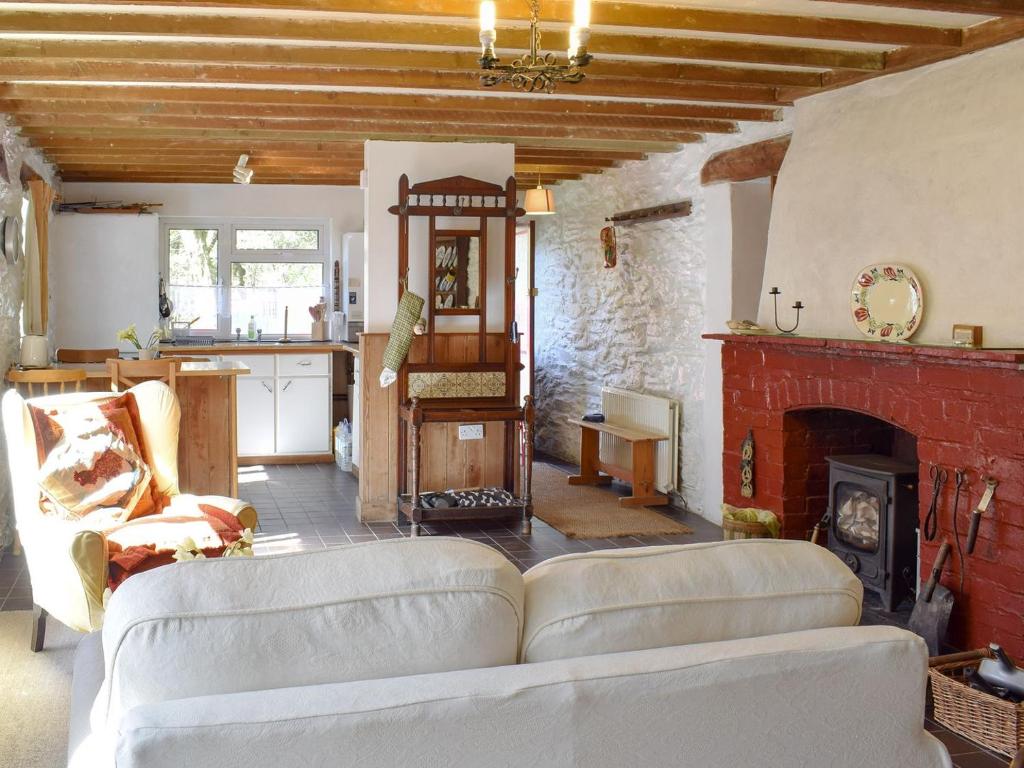 a living room with a couch and a fireplace at The Glen in Devils Bridge