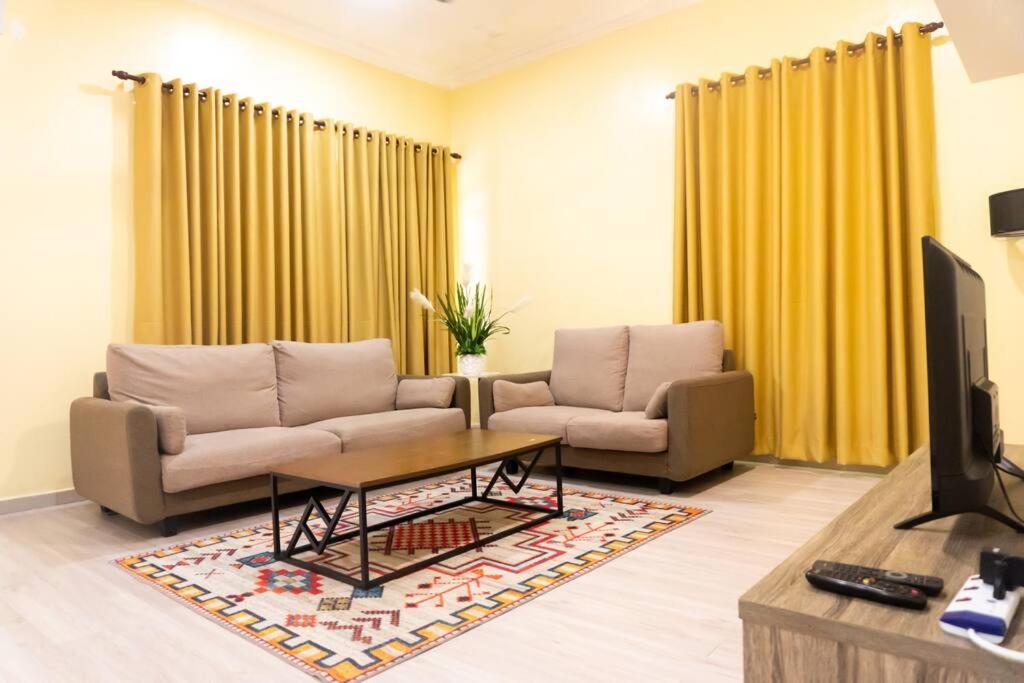 a living room with two couches and a tv at 5 Bedrooms Homestay with Private Pool (SEROJA) in Nilai