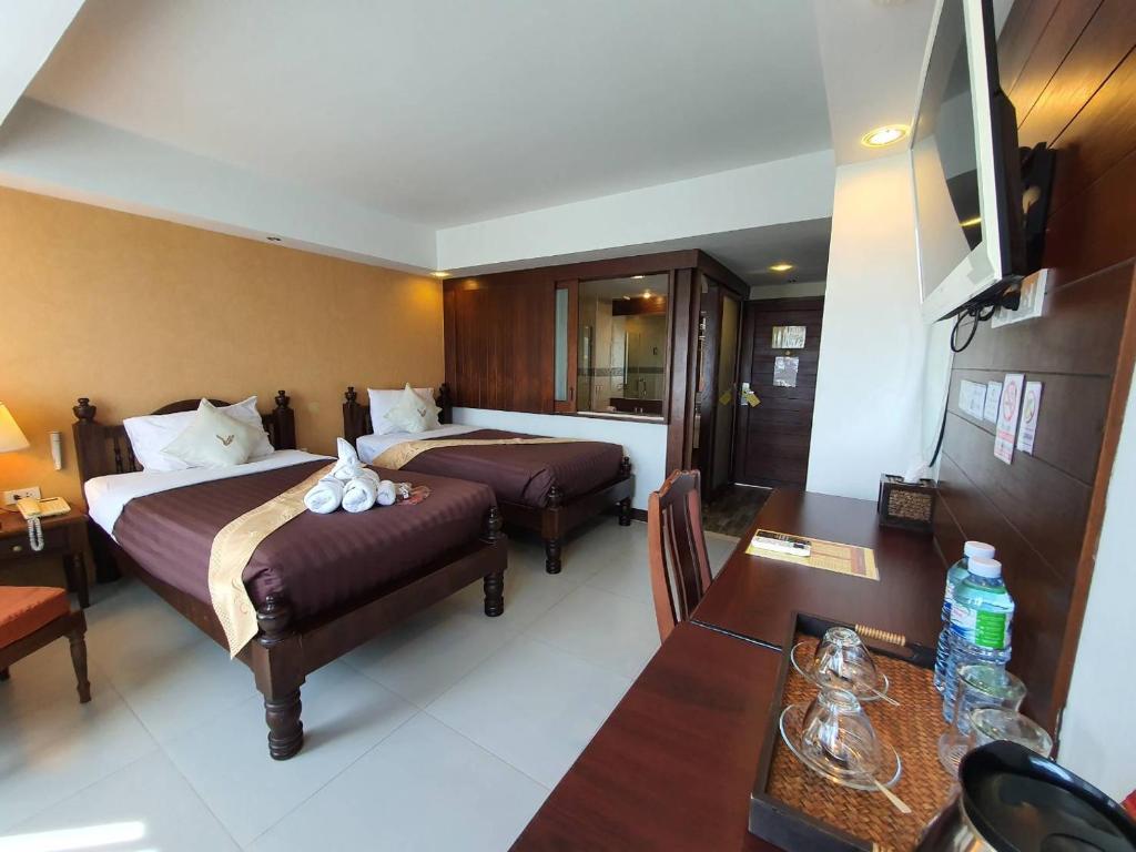 Postel nebo postele na pokoji v ubytování Goldenbell Hotel Chiangmai
