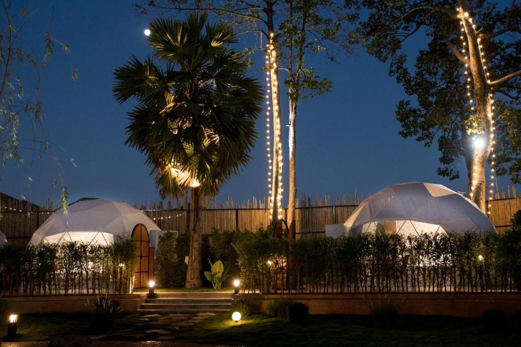 two domes in a garden at night at PaPa Q suite Resort in Roi Et