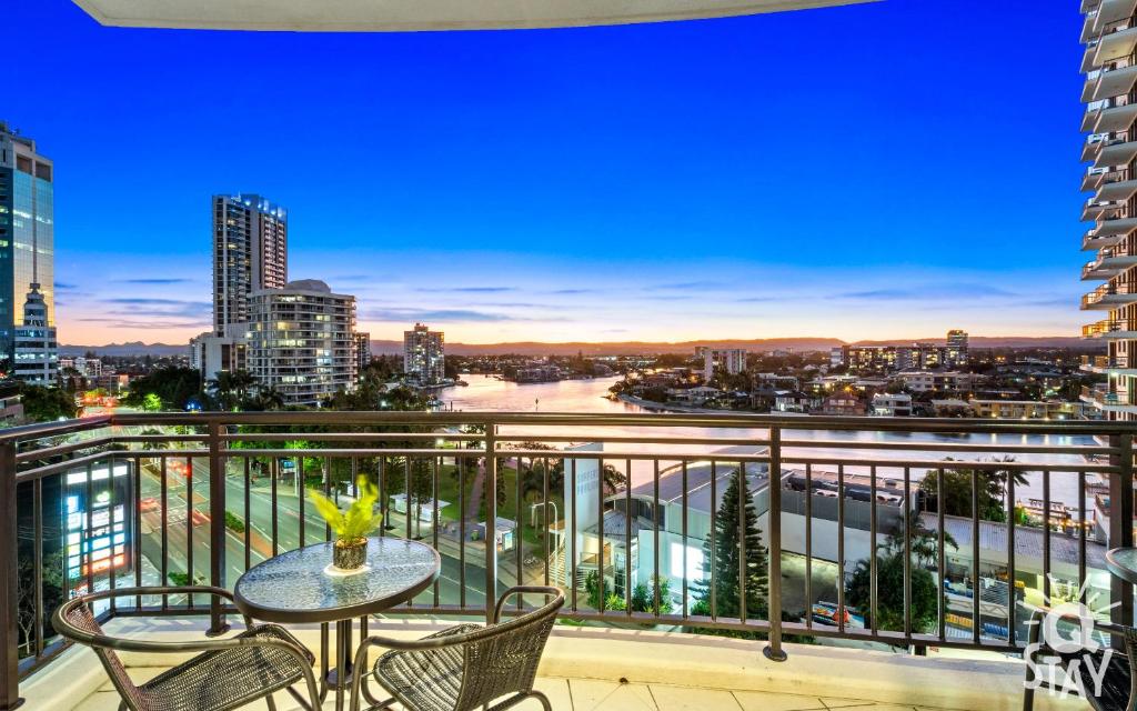 a balcony with a table and chairs and a city skyline at 2 Bedroom 1 Bathroom Apartment - Centre of Surfers Paradise, Chevron Renaissance in Gold Coast